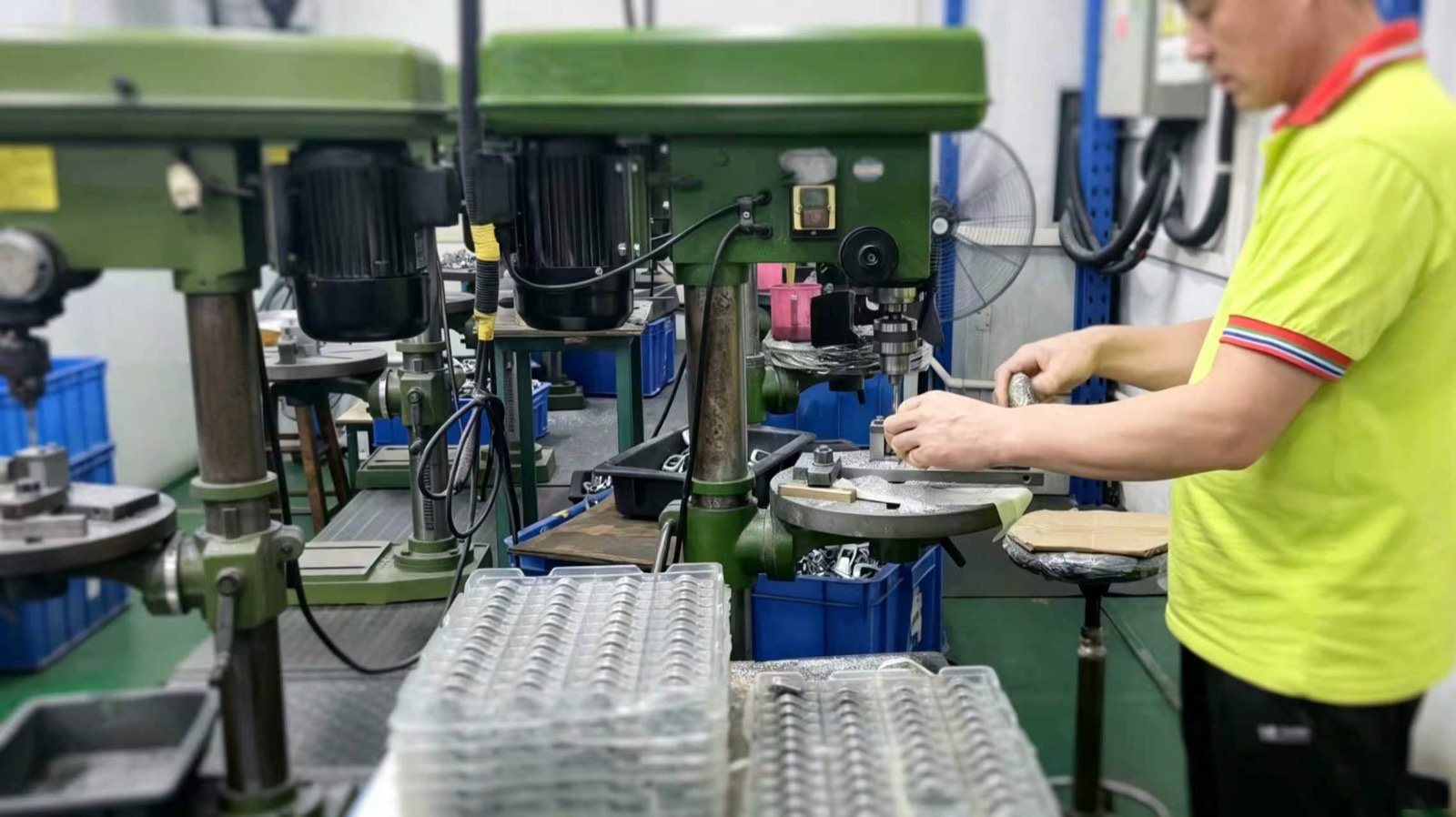 Drill press stations running secondary operations on stamped metal parts at Fudakin's Shenzhen plant.