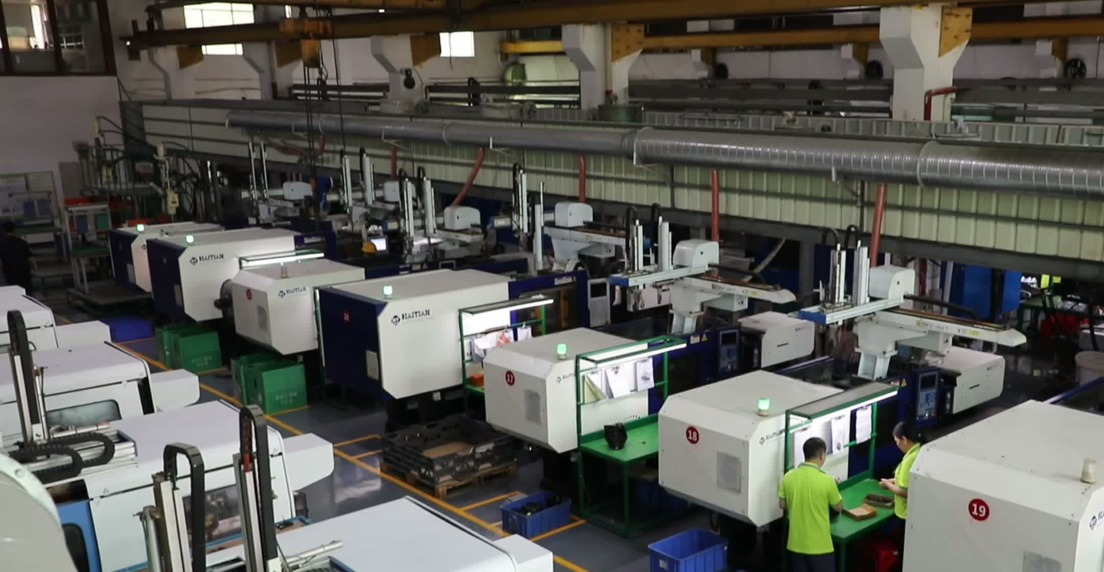 Wide view of a Fudakin injection molding floor bay, rows of molding machines running production.